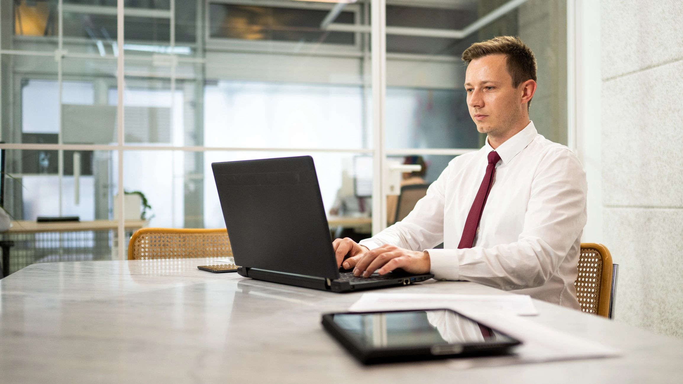 Technology consultant working on a laptop in an office